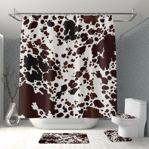 Detail of 4-piece bathroom set with brown cow print shower curtain and matching floor mats