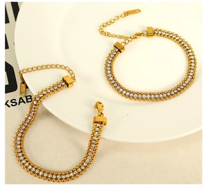 Detail of double-row crystal bracelet in gold finish with K18 tag and adjustable clasp