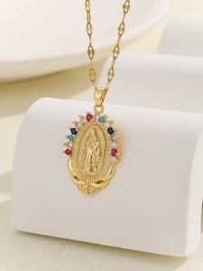 Macro shot of Virgin Mary pendant with multi-color zircon stones on a white stand