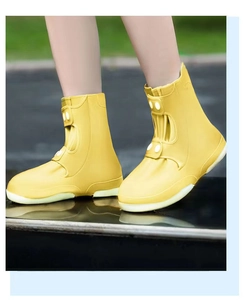 Detail of yellow waterproof silicone shoe cover with adjustable buckle and thick sole