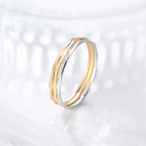 Macro detail of 1mm tricolor geometric stackable ring with elegant rhombus-cut finish