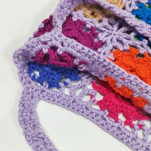 Close-up of vibrant crochet tote bag showing intricate multi-color knit patterns