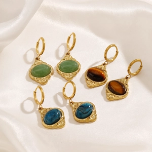 Vintage gold oval earrings featuring natural tiger eye and aventurine on white silk