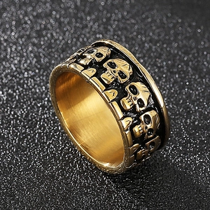 Macro shot of gold-plated stainless steel ring featuring a detailed skull relief design