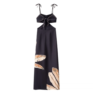 Detail of sexy backless dress featuring bow-tie straps and tropical leaf print
