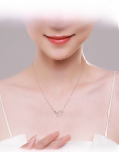 Close-up of minimalist sterling silver necklace with interlocking crystal rectangles