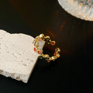 Detailed macro shot of adjustable gold plated ring set with multi-color zircon stones