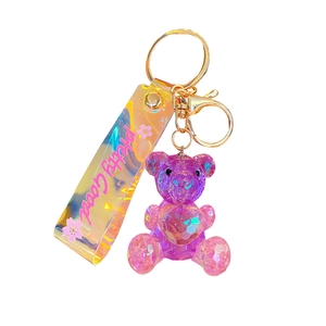 Geometric purple crystal heart bear keychain with iridescent strap and gold hardware