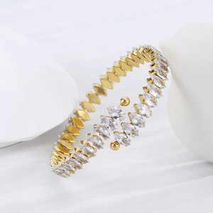 Macro detail of 18K gold-plated bangle featuring sparkling marquise-cut cubic zirconia stones