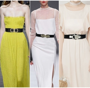 Detailed views of women's black elastic waist belts with pearl and rhinestone metal buckles