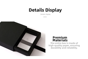 Detail of matte black drawer jewelry box with textured paper and woven ribbon pull tab