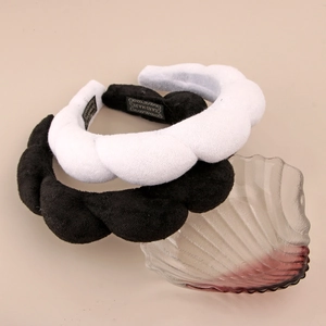 Detail of handmade padded sponge headband featuring thick velvet texture in black and white