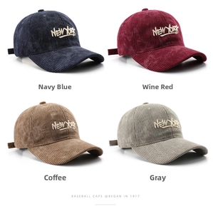 Detail shot of corduroy baseball caps in navy, burgundy, coffee, and gray colors
