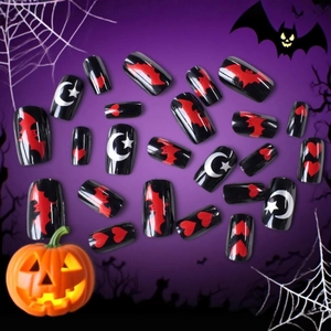 Halloween press-on nails with dark bat, moon and star patterns on a black base