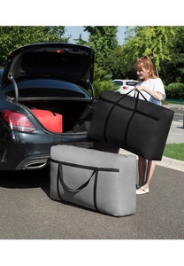 Black and grey Oxford storage bags being loaded into a car trunk for moving clothes