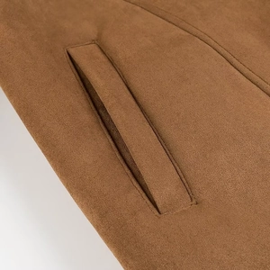 Close-up of the welt pocket on brown suede jacket showing stitching details