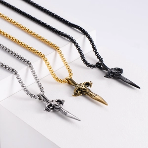 Macro detail of vintage sword pendants featuring ram skull motifs and box chain textures