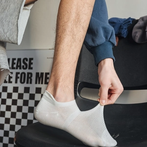 Close-up of white breathable mesh cotton socks showing high elasticity and stretch fit