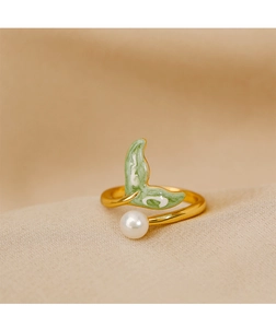 Close-up of golden fish tail ring with green enamel finish and white freshwater pearl