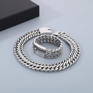 Polished silver stainless steel jewelry set with 23mm woven Cuban link necklace and bracelet