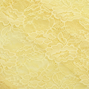 Close-up of yellow floral lace fabric detailing exquisite mesh texture and patterns
