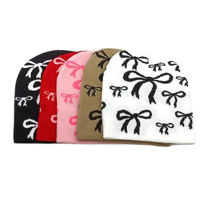 Bowknot pattern jacquard knit beanie hats for women in white, khaki, pink, red, and black