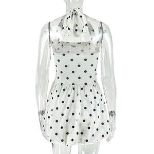 Detail of white halter neck dress with navy polka dots and backless tie closure