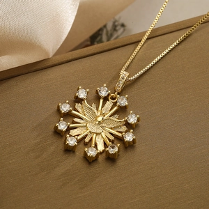 Gold angel dove pendant necklace with sparkling cubic zirconia on a luxury box