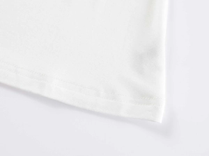 Close-up of double-needle stitching on the hem of a white knit V-neck T-shirt