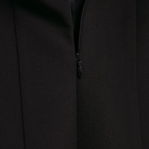 Close-up of black off-shoulder dress featuring a high-quality invisible back zipper
