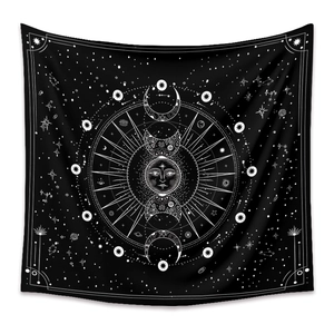 Close-up of bohemian mandala tapestry featuring sun moon phases and celestial star patterns