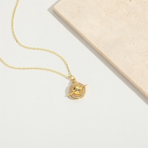Golden saturn planet pendant necklace with white zircons on minimalist white background