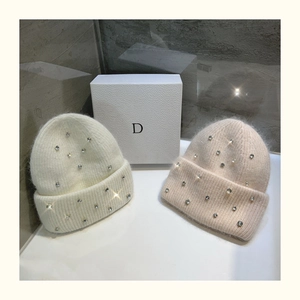 Close-up of knit rabbit fur hats with rhinestone accents and thick warm texture