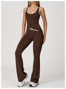 Detail of cross high-waist yoga pants and chocolate brown tank top with white contrast trim