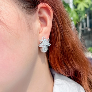 Elegant silver flower earrings with zircon pavé and hanging white round pearl on model