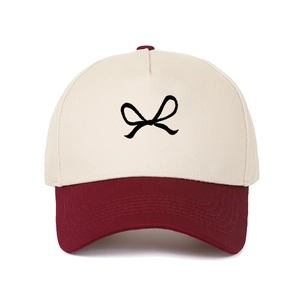 Two-tone baseball cap in off-white and burgundy with black bow embroidery