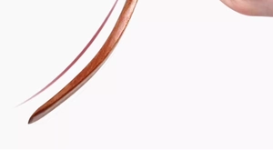 Detailed view of an ebony wood spatula handle with a red string loop held by hand