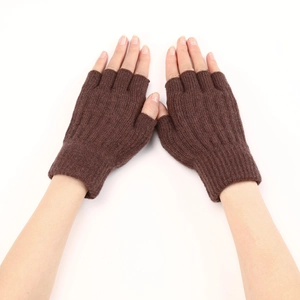 Detailed close-up of brown knit cable pattern on warm half-finger gloves