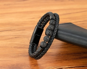 Detail view of double-layer black braided leather bracelet with natural volcanic lava stones