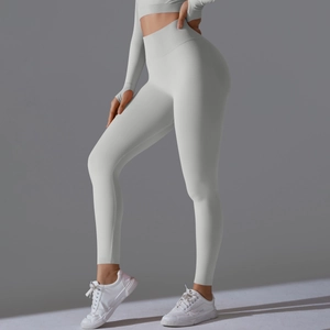 Detail of light gray high-waisted leggings and long sleeve top with thumbholes