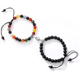 Detail of magnetic tiger eye couples bracelets with colorful beads and black woven cord