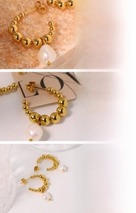 Detailed view of gold beaded C-hoop earrings featuring natural freshwater pearl charms