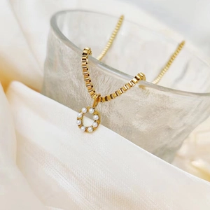 Elegant gold-plated titanium steel necklace with pearl circle pendant and box chain.