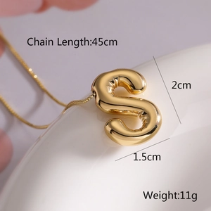 Macro shot of 3D balloon letter S gold pendant necklace with size and weight dimensions
