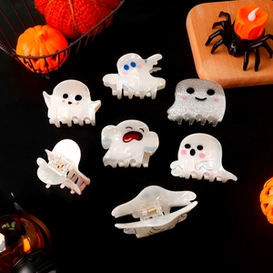 Ghost themed Halloween hair clips with iridescent finish and glitter details on black background