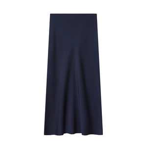 Detail of navy blue midi skirt showing smooth silk texture and elegant drape on white background