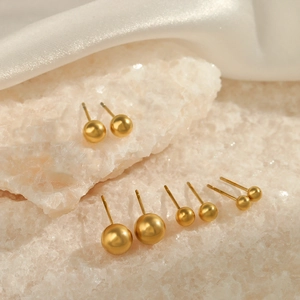 Minimalist gold stainless steel ball stud earrings set shown on elegant white silk background