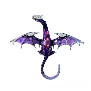 Macro shot of purple enamel flying dragon brooch with pink gemstones and rhinestones
