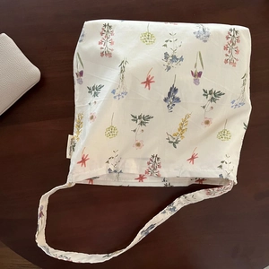 Floral printed beige cotton tote bag with botanical tulip patterns and a shoulder strap