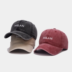 Detailed macro view of vintage washed cotton baseball caps with MILAN embroidery